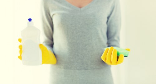 Local technician treating a coffee stain on a sofa in a Hammersmith home